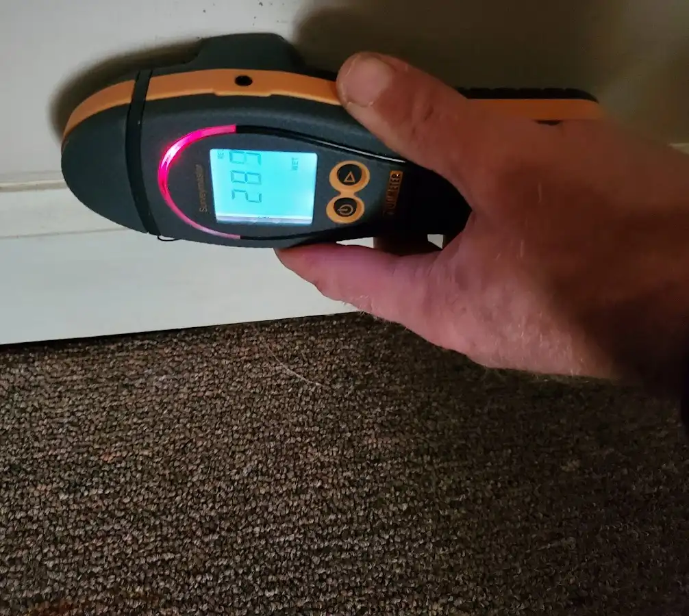 Moisture detection at baseboard during Storm Damage Restoration in Sandersville